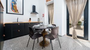 a dining room with a table and chairs at Unique Beautifully Restored Town House in Loulé