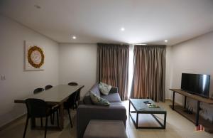 a living room with a couch and a table at Riviera Residence Luxury by Cozy in Accra