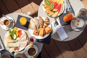 two plates of food on a table with breakfast foods at Radisson Blu Resort & Spa in Split