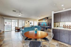 a living room with a couch and a table at Deerbrook Manor Permit# 67085 in La Quinta