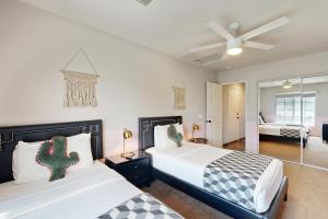 a bedroom with two beds and a living room at Deerbrook Manor Permit# 67085 in La Quinta +18 photos