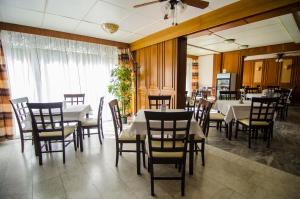 a dining room with tables and chairs and a ceiling at Solar Club Apartman Sopron in Sopron