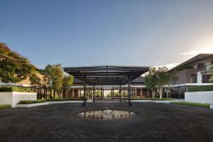 a building with a fountain in the middle of a courtyard at Radisson Blu Bali Uluwatu in Uluwatu