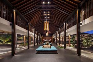 a large building with two beds in the middle at Radisson Blu Bali Uluwatu in Uluwatu
