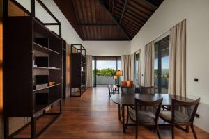 a dining room with a table and chairs at Radisson Blu Bali Uluwatu in Uluwatu