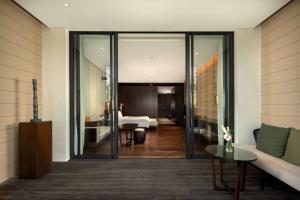 a living room with a door leading to a bedroom at Radisson Blu Bali Uluwatu in Uluwatu