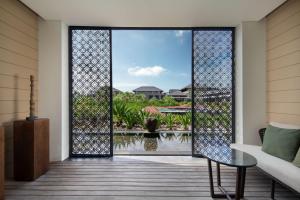 an open door with a view of a pool at Radisson Blu Bali Uluwatu in Uluwatu