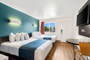 a hotel room with two beds and a flat screen tv at Studio 6 Suites Carpinteria, CA Santa Barbara South in Carpinteria +22 photos
