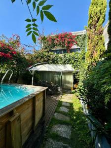 einen Hinterhof mit einem Pool, einem Tisch und einem Sonnenschirm in der Unterkunft Exclusive Luxury Villa with S-pool & Garden in Porto