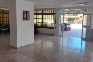 an empty room with a lobby with glass doors at Cozy 2-Bed & Sofa-bed Studio - Pool Pets Wifi in Los Cristianos +26 photos