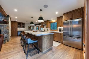 a kitchen with wooden cabinets and stainless steel appliances at Eclipse Retreat at Tahoe Park - Hot Tub - Fenced Yard & steps to HOA Access in Tahoe City