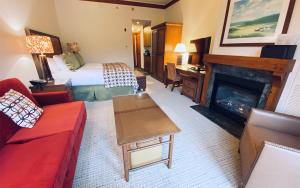 a hotel room with a bed and a fireplace at 1234 Lodge At Spruce Peak Ski In Ski In Ski Out King Studio By Stowe Mountain Rentals in Stowe