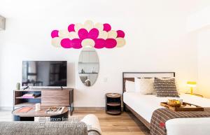 a bedroom with a bed with a large flower on the wall at Kukun Reforma & Downtown in Mexico City
