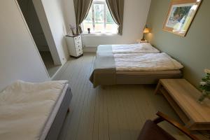 a bedroom with two beds and a window at Övermark Bed & Breakfast in Ylimarkku