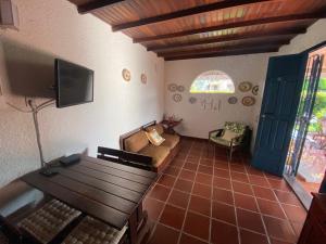 a living room with a couch and a tv at Recanto do Sal, casa completa com SKY e WI-FI in Salinópolis
