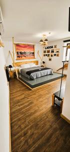 a bedroom with a large bed and a wooden floor at Atlantic Spot Guest House in Praia de Mira