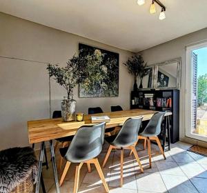 a dining room with a wooden table and chairs at Holiday house with a swimming pool Stanici, Omis - 22998 in Omiš