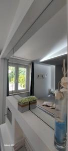 a white room with a bed and a vase on a table at Villa Anna Maria in Capo Vaticano