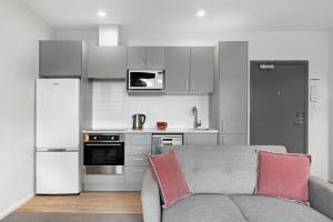 a living room with a couch and a kitchen at Haeata View in Queenstown