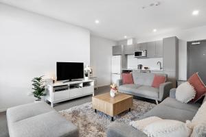 a living room with two couches and a tv at Haeata View in Queenstown +9 photos