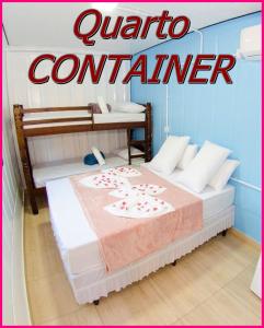 a bedroom with two beds with the words quattro contender at Pousada Helena in Penha +12 photos