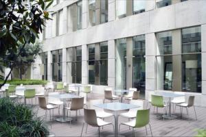 a row of tables and chairs in front of a building at DOWNTOWN APT Pool & Gym in Mexico City