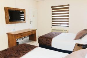 Postel nebo postele na pokoji v ubytování Hotel Sntenario