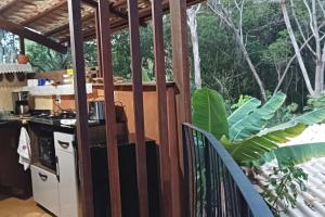 a balcony with a kitchen and a stove at Casa Sustentável de Terra! in Lençóis