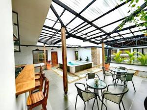 a patio with tables and chairs and a pool at Espectacular casa Campestre con Jacuzzi in Salento