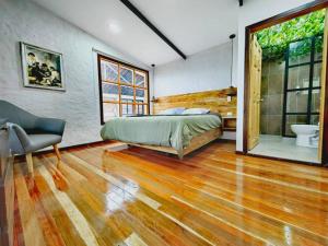 a bedroom with a large bed and a bathroom at Espectacular casa Campestre con Jacuzzi in Salento +13 photos