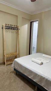 a bedroom with a bed with two towels on it at Casa em Porto - Casa Beija Flor in Porto Seguro +24 photos