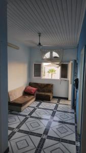 a living room with a couch and a tile floor at شقة شارع 101 in Ras El Bar