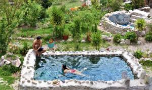 a couple of people in a pool in a garden at El Huayllar in Cusco