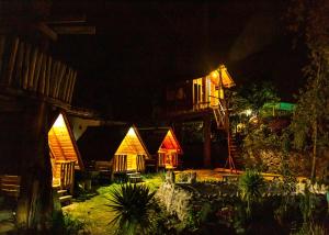 a group of houses at night with lights at El Huayllar in Cusco