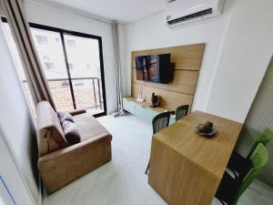 a living room with a couch and a table at Ap no Coração de Porto de Galinhas Paulo Brito 101 - By Anfitrião Legal in Porto De Galinhas