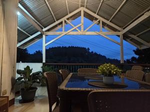 a patio with a table and chairs and a view at Davao City-Marilog Peak Cafe- Traveler's Staycation in Davao City