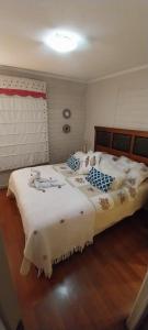 a bedroom with a large bed with white sheets at 1 habitación comoda in Santiago +6 photos