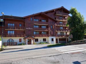 a large apartment building on the side of a street at Duplex de Charme pour 6 Personnes, Proche Centre et Pistes de Ski - FR-1-505-209 in Notre-Dame-de-Bellecombe
