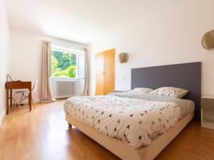 a bedroom with a large bed and a window at Maison typique 10 pers. avec Wifi, jardin et terrasse, à 5 min de Loudenvielle - FR-1-695-58 in Avajan