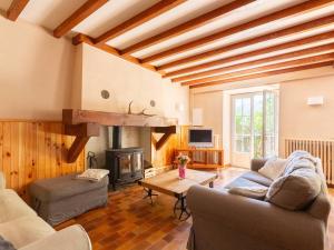 a living room with a couch and a fireplace at Maison typique 10 pers. avec Wifi, jardin et terrasse, à 5 min de Loudenvielle - FR-1-695-58 in Avajan