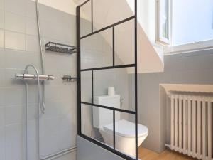 a bathroom with a toilet and a glass shower door at Maison typique 10 pers. avec Wifi, jardin et terrasse, à 5 min de Loudenvielle - FR-1-695-58 in Avajan +10 photos
