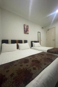 Postel nebo postele na pokoji v ubytování Hotel Mutiara KGMMB, Melaka