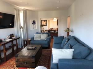 a living room with blue couches and a table at Oasis Point in Richmond