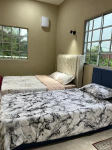 two beds sitting next to each other in a bedroom at Al-Hijrah Homestay Meru Klang in Kapar +50 photos