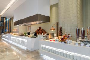 a kitchen with aasteryasteryasteryasteryasteryasteryasteryasteryasteryasteryasteryastery at Awaken Da Nang Hotel in Danang