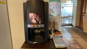 a black coffee maker sitting on top of a table at Hakodate Hotel Ekimae - Vacation STAY 91718v in Hakodate