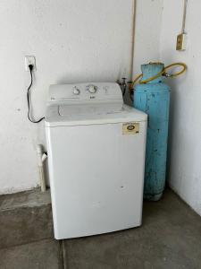 a small white refrigerator next to a blue vase at Casa Flor de Mayo in Santa Cruz Huatulco +6 photos