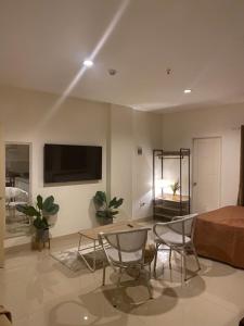 a living room with a bed and a table and chairs at Amar Residence in Iligan