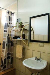 a bathroom with a sink and a mirror at Apartamento Colca 's Home, cuenta con dos habitaciones in Chivay