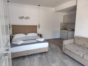 a bedroom with a bed and a couch at Ariadne's garden in Astris